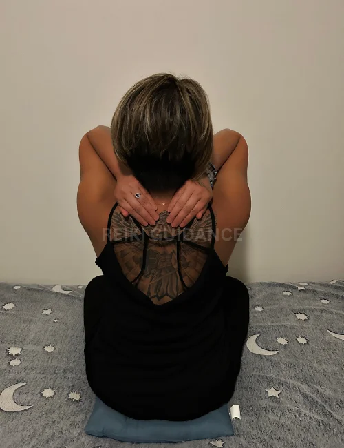 Woman with hands over the shoulders, an essential Reiki self-healing position